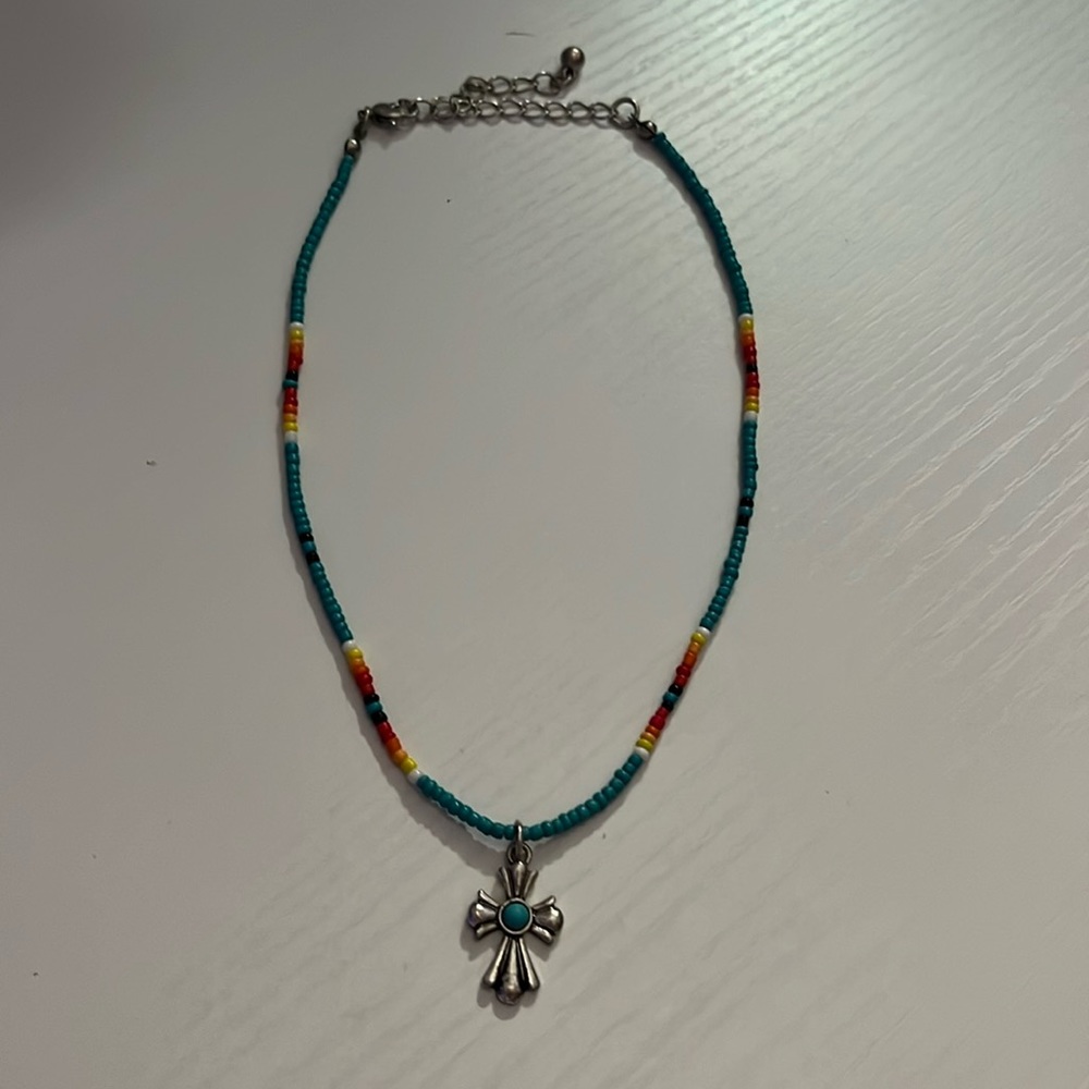 Cross necklace, mostly turquoise, never worn, from a boutique.